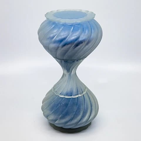 Light blue frosted glass hourglass vessel with a twisted diagonal swirl pattern.