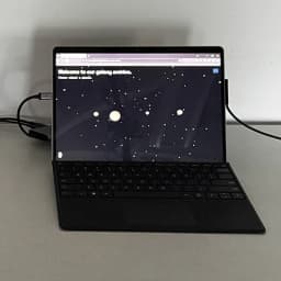 Tablet showing the Planetary Archive site with selectable planet icons on a star field.
